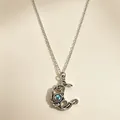 Close-up of retro silver moon pendant necklace with central blue moonstone detail - Moon Style