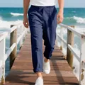 Detail shot of men's loose navy linen beach pants with drawstring waist on pier - S / Bottoms / Navy Blue