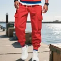 Detailed outdoor view of red heavy-duty men's cargo pants with functional multi-pocket design - S / Bottoms / Red