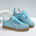 Close-up of blue glitter sneakers featuring sparkling sequins and brown rubber soles - 35 / Teal