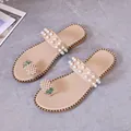 Elegant beige flat sandals featuring pearl-studded straps and a pineapple rhinestone charm - 35 / Off White