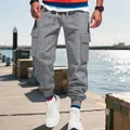 Detail of men's grey heavy cargo sweatpants featuring multiple side pockets and cuffed hems - Dark Gray