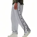 Side view of grey men's basketball tear-away pants with snap buttons - Gray