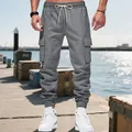 Close-up detail of grey men's heavyweight cargo joggers featuring drawstring and side pockets - S / Bottoms / Dark Gray