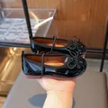 Elegant shiny black patent leather girl's princess shoes with a cute bow detail - Black