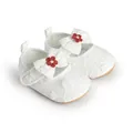 Detailed macro view of white lace infant walking shoes featuring a delicate bow and red floral accent - 11cm / White