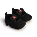 Close-up of black baby walking shoes with bow and red flower embroidery detail. - 11cm / Black