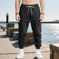 Close-up of men's heavyweight black cargo sweatpants with multi-pockets and drawstring. - S / Bottoms / Black