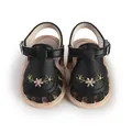 Top view of black baby sandals with floral embroidery and cut-out details - 11cm / Black