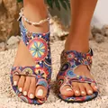 Detail view of women's bohemian flat sandals with colorful ethnic print and toe ring - Multicolor