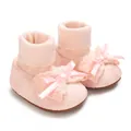 Close-up detail of soft pink baby girl sock shoes featuring a delicate lace bow design - Pink