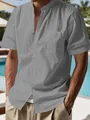 Close-up of a gray linen shirt's henley collar and chest pocket on a male model. - S / Tops / Gray