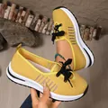 Close-up of yellow lightweight fly-knit women's sneakers with breathable mesh detail - 36 / Yellow