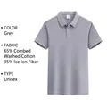 Detailed view of gray unisex polo shirt highlighting fabric blend and split hem - S / Tops / Gray