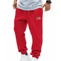 Detail of red American style loose sweatpants for men featuring a small US flag patch - S / Bottoms / Red