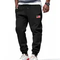 Close-up of men's black relaxed fit sweatpants with American flag patch detail - S / Bottoms / Black