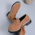 Close-up detail of tan suede chunky loafers showing stitching and lug sole texture. - Dark Brown