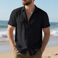 Detail view of a black men's linen beach shirt showing chest pockets and fabric texture - Black