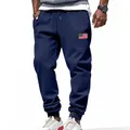 Detail view of navy blue men's joggers with American flag patch and ribbed cuffs - S / Bottoms / Navy Blue