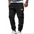 Close-up detail of black American style men's sports joggers featuring a US flag patch - S / Bottoms / Black