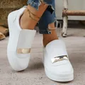 Close-up detailed view of white platform sneakers featuring a decorative gold plate - 36 / White