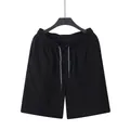 Casual black linen drawstring shorts for men, perfect for summer beach and sports. - Black