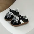 Trendy girls' black and white German trainer sneakers with sweet bow tie accents. - Size 26 / German Training Shoes (9858) / Inner Length 16cm / Black