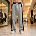 Close-up view of grey and black color-block men's straight leg fleece sweatpants in a mall - S / Bottoms / Light Grey/Black