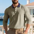 Detail of a male model wearing a khaki long-sleeved polo shirt with a navy contrast collar - Brown