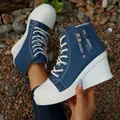 Close-up of blue denim high-top wedge sneakers with white thick sole and zipper detail. - 35 / Dark Blue