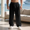 Men's loose black linen trousers with drawstring waist in casual resort setting - S / Bottoms / Black