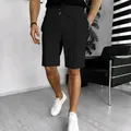 Detail of men's black waffle knit shorts showing texture and relaxed straight fit. - S / Bottom (DK100) / Black