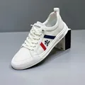 Men's stylish white leather sneakers with red and blue side stripes and low top design - 38 / White