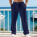 Detailed view of men's navy waffle knit straight-leg lounge pants in a seaside setting - S / Bottoms / Navy with Black Label