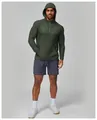 Close-up of green quick-dry hooded fitness jacket for men with 1/4 zip design. - S / Tops / Dark Green
