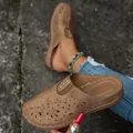 Close-up of brown closed-toe hollow-out mules with metal stud details and comfort sole. - 36 / Khaki
