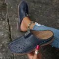 Casual blue closed-toe mules with laser-cut floral patterns and comfortable brown soles - Navy Blue