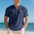 Detail of navy blue linen Henley shirt featuring a textured fabric and front pocket. - S / Tops / Navy Blue