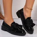 Elegant black patent leather loafers with a large decorative bow and a thick block heel - Glossy Black