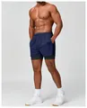 Detail view of men's quick-dry 2-in-1 athletic shorts in navy blue on a fitness model - S / Bottoms / Black