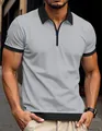 Close-up of men's grey waffle knit polo shirt with black contrast trim and zipper - S / Tops / Gray