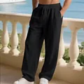 Detailed shot of men's loose black linen pants with pleated knee texture and drawstring - Black