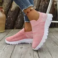 Detailed view of pink breathable fly-knit slip-on sneakers with chunky white soles - 36 / Pink