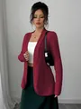 Detailed view of women's red ribbed cardigan styled with white tube top and green skirt - S / Tops / Burgundy