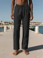 Pantalones de playa de lino negro para hombre con cordón, mostrados en un muelle - Negro