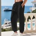 Detail of men's black linen casual pants with drawstring waist and elastic cuffs. - S / Black