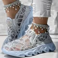 Macro detail showing the sequined mesh upper and pearl fringe on white platform shoes. - Silver