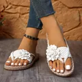 Vista detallada de elegantes sandalias blancas tejidas con un adorno floral decorativo - 36 / Blanco
