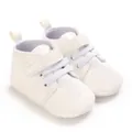 Detail view of white infant baptism shoes featuring delicate cross embroidery design - White (Silver Embroidery)