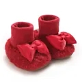 Detailed view of red fleece baby girl booties with large satin bow decoration - Red